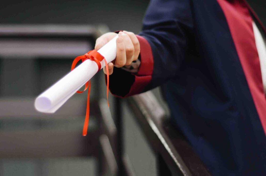 A graduate with their diploma.